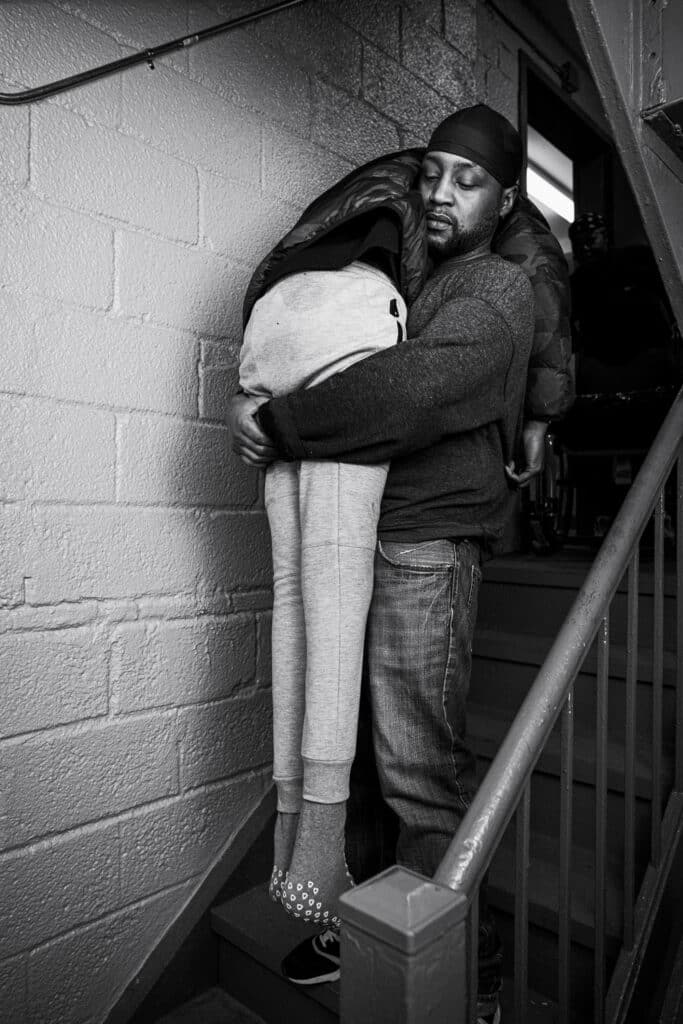 Phat Boy carries Malik down four flights of stairs.