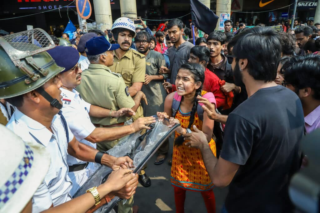 KOLKATA, WEST BENGAL, INDIA- 2020-03-01: A protester drags the sheild of a police personnel, while she was being arrested during a protest rally against CAA. © Jit Chattopadhyay