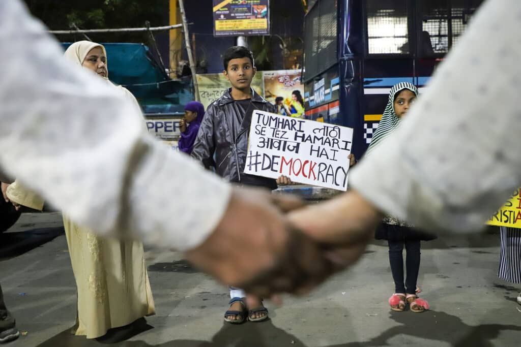 KOLKATA, WEST BENGAL, INDIA- 2020-02-25: A muslim boy holds a placard written "Tumhari laathi se tez hamari awaz hai #Democracy" ("Our voice is louder than your sticks") during a protest rally against the torture of police in New Delhi. © Jit Chattopadhyay