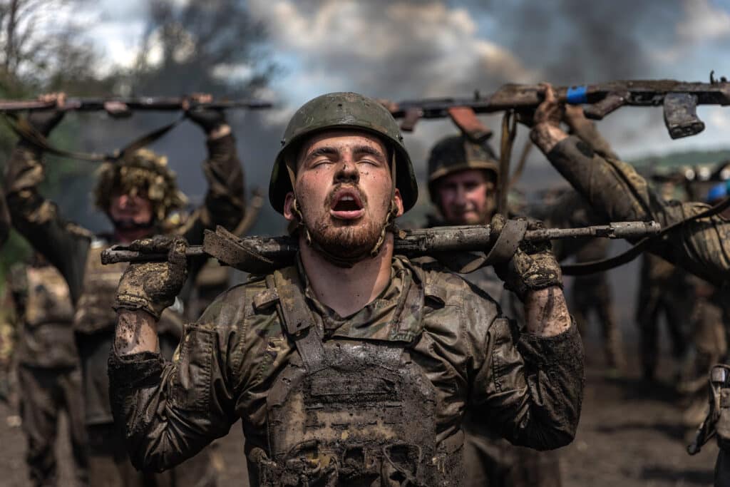 ALieutenant Arseniy, nicknamed “Schultz” marches forward with fellow Marines from the 36th Brigade during an initiation event near the town of Pokrovske in the Zaporizhzhia region. Before they are sent back to the frontlines to face Russian forces in the ongoing counteroffensive, Ukrainian Marines from the 36th Brigade took part in an initiation, enduring a grueling 7 kilometer run through obstacles and challenges simulating the real life and death struggles ahead. © David Guttenfelder for The New York Times