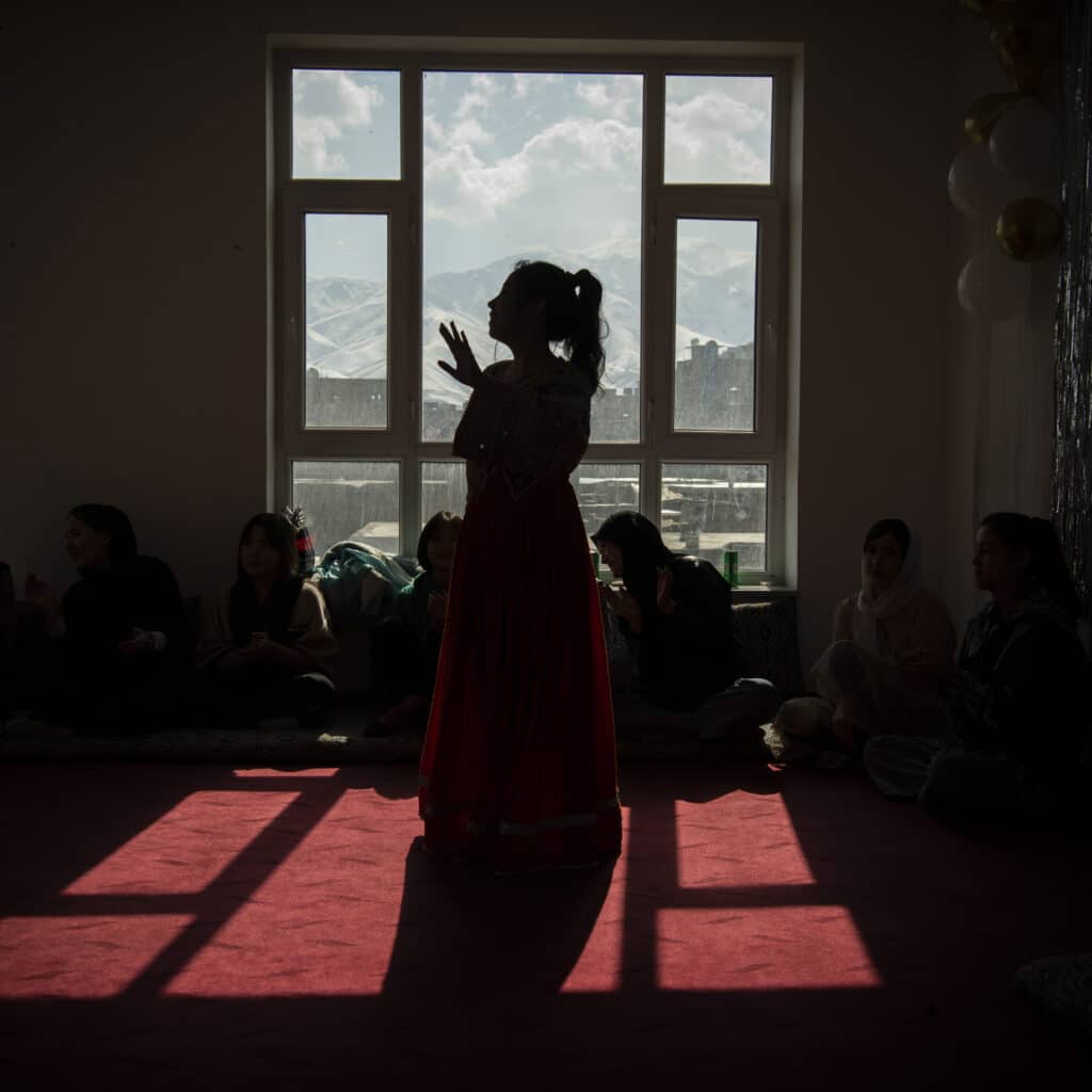 Kabul, Kabul, Afghanistan, February 23, 2024. A group of teenage girls dance at a birthday party of their friend. Music and dancing have been forbidden by the Taliban but women continue to dance and celebrate in the privacy of their homes and behind closed doors. © Kiana Hayeri for Fondation Carmignac