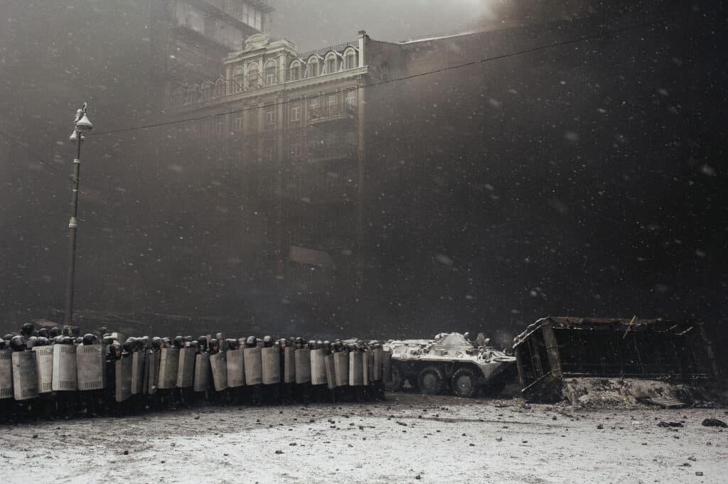 After the clashes with the protesters riot police protected APC which takes away burned buses from the carriageway in the center of Kiev on Jan. 22, 2014. © Maxim Dondyuk