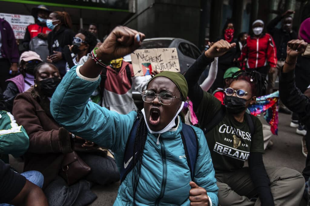 Protesters in Nairobi, Kenya shout slogans during a demonstration against tax hikes as members of Parliament debate the financial bill. June 19, 2024. © Samson Otieno