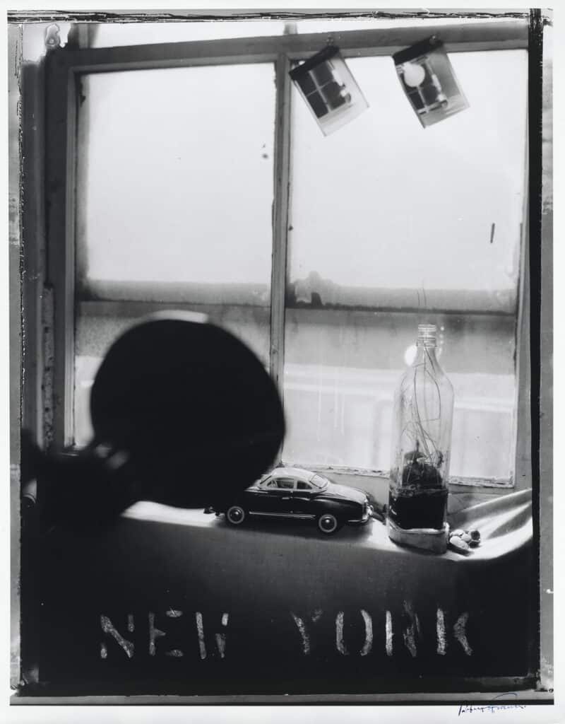 Pablo’s Bottle at Bleecker Street, New York City, 1973 © Robert Frank, 2024 The June Leaf and Robert Frank Foundation