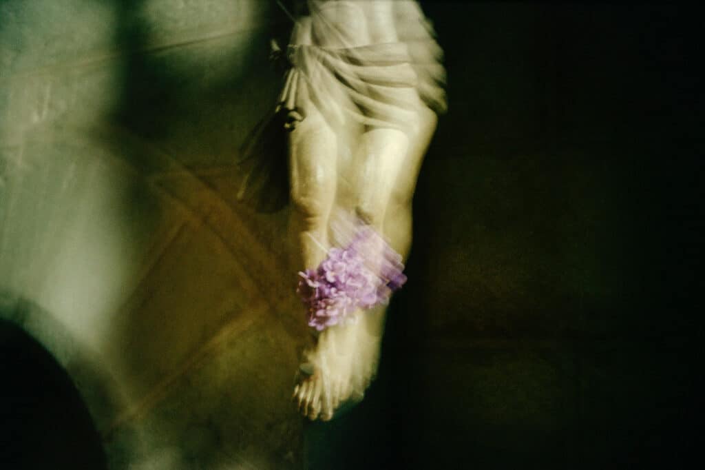 Lilacs between Jesus’s legs, Aubazine church, France, 2005 © Nan Goldin, Courtesy the artist and Gagosian