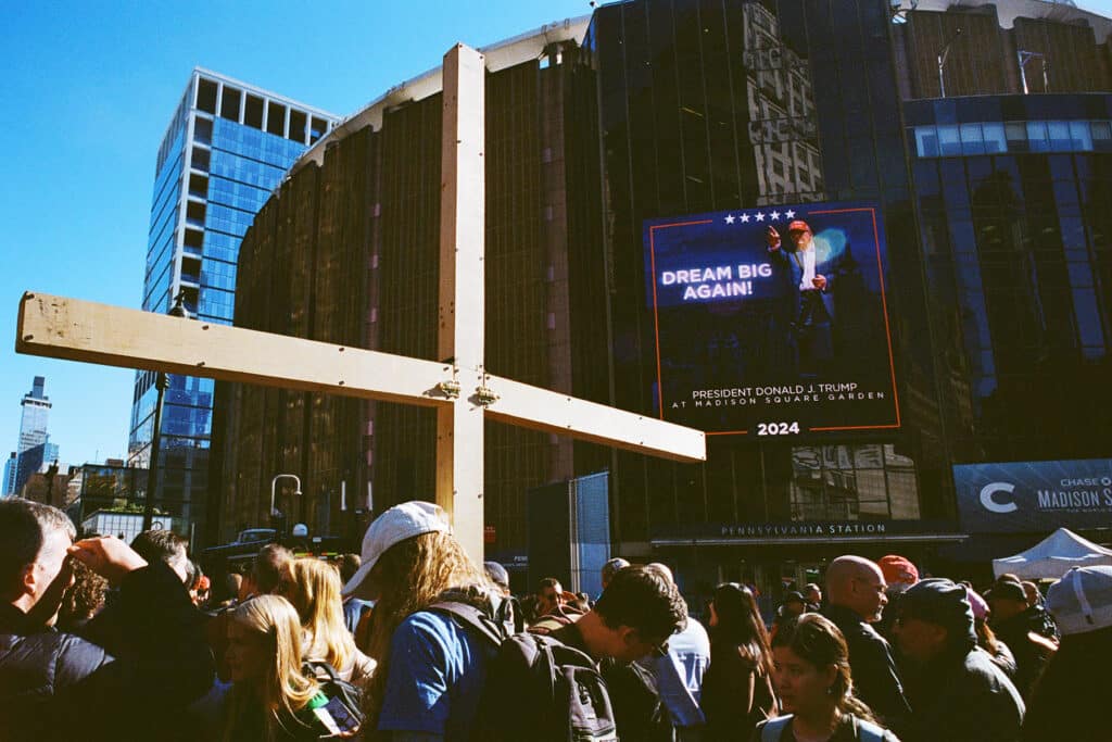 Trump Supportors with a large wooden cross at the Donrald Trump Rally at Madison Square Garden. New York City. October 27, 2024 © Robert E. Gerhardt