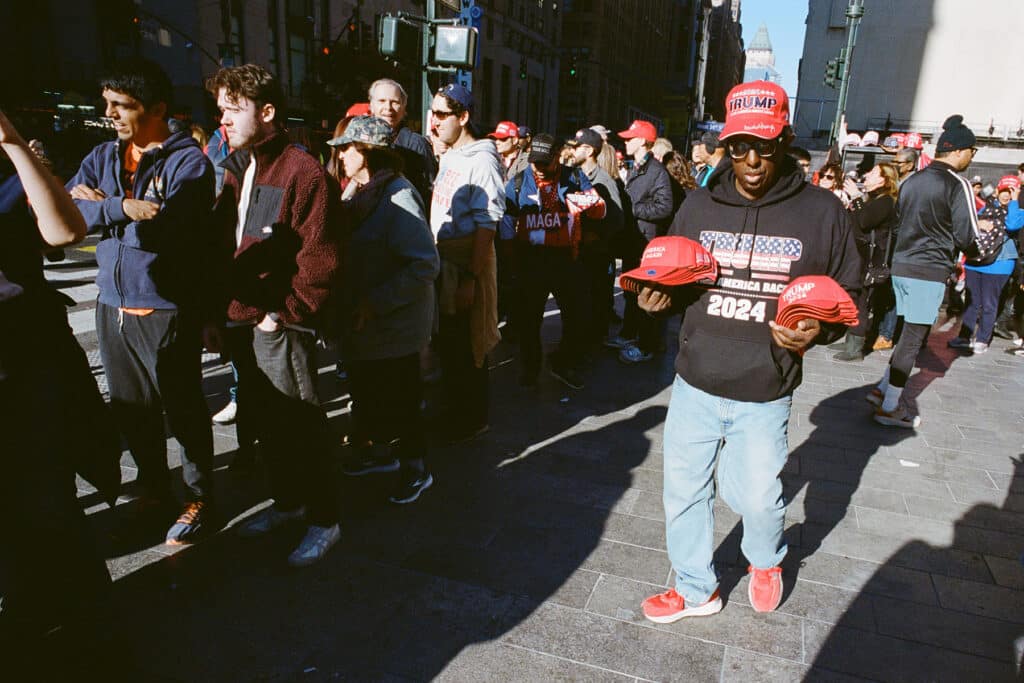 Man Seeling Trump Hats at the Donald Trump Rally at Madison Square Garden. New York City. October 27, 2024 © Robert E. Gerhardt