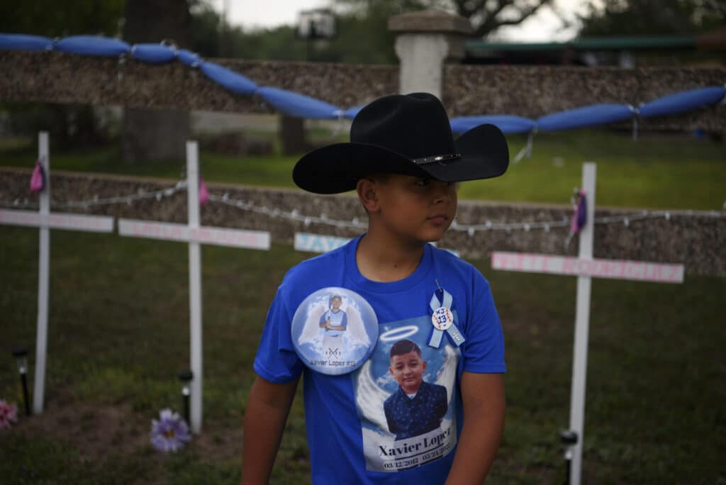 June 7th, 2022. Uvalde, Texas. JT Martinez, 9, a close relative and the best friend of Xavier Lopez, who was killed in a mass shooting at Robb Elementary School, wears a cowboy hat as he and his family prepare to attend Xavier’s funeral. © Callaghan O’Hare for The New York Times