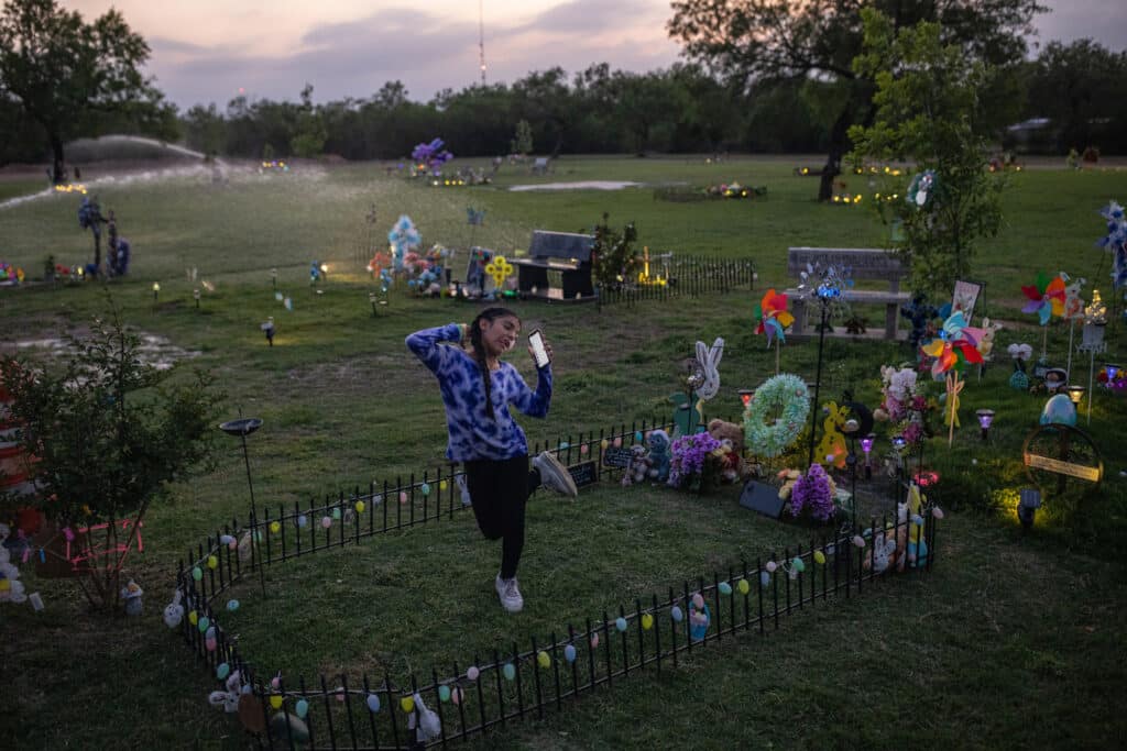 Caitlyne Gonzales, who lost many of her friends in the shooting, sang and danced to Taylor Swift songs at her friend Jackie Cazares’ grave in Uvalde, Tex., on April 19, 2023. (Tamir Kalifa)