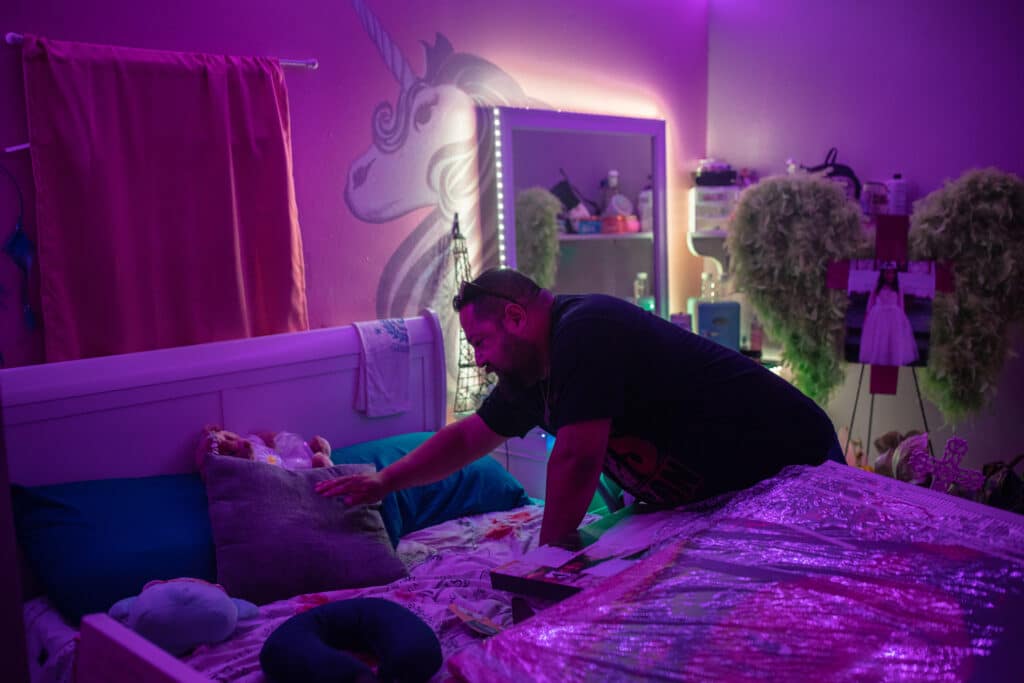 Javier Cazares speaks to his daughter, Jackie, 9, in her bedroom in Uvalde, Tex., before going to sleep on June 13, 2022. Jackie was among the 19 children and two teachers killed in the shooting at Robb Elementary School. She loved her family and friends and had dreams of one day visiting Paris.