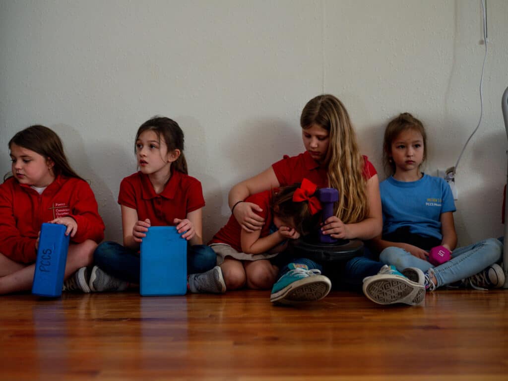 3rd-grade teacher Danika Nuttall waits to shoot simulation rounds at armed intruders inside a fake classroom at the Utah County Sheriff's training facility. Spanish Fork, Utah. July 2022. © Zachary Canepari