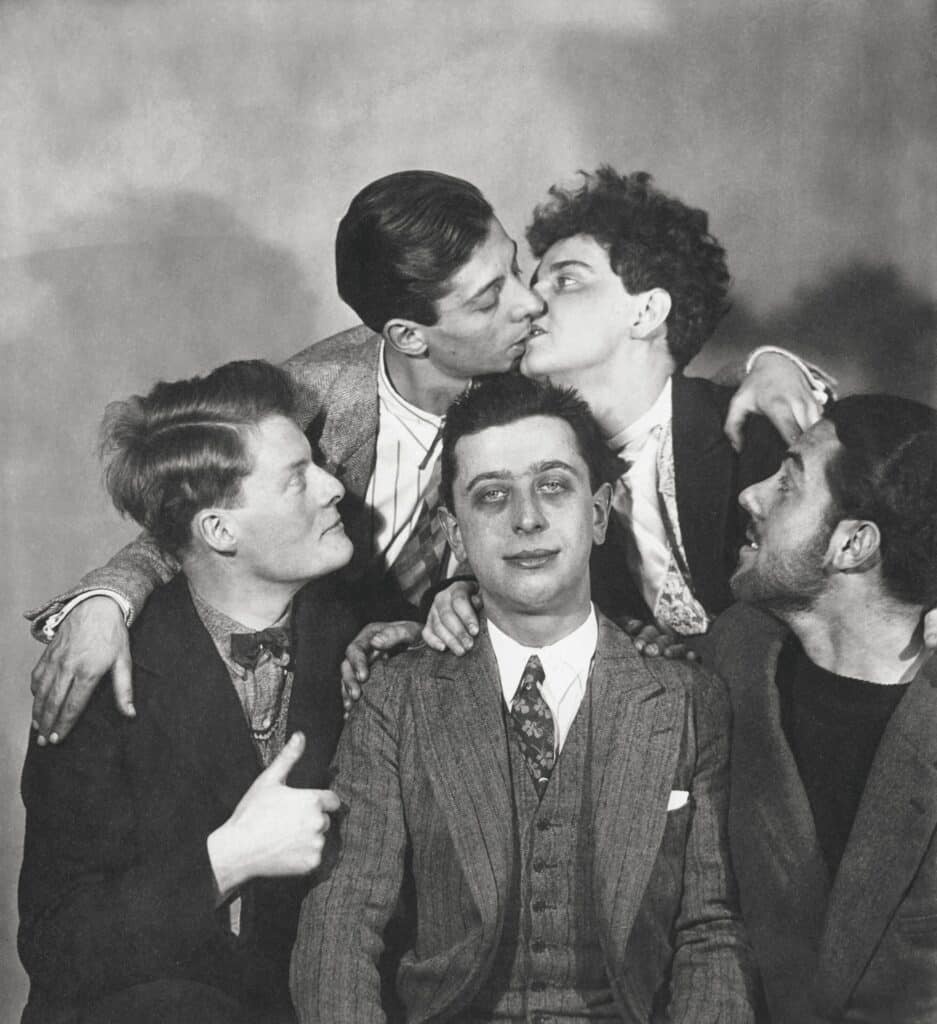 Surrealist group: Robert Desnos center and André la Rivière (left), André Lasserre; Georges Malkine kissing Yvette Ledoux, 1925 © Man Ray 2015 Trust / ADAGP, Paris, 2025