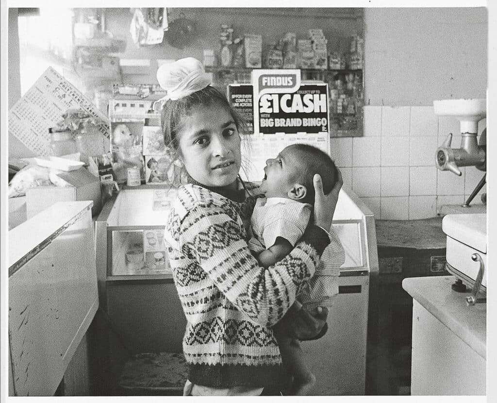 Dennis Morris, Young shop attendant, Southall, 1974 © Dennis Morris